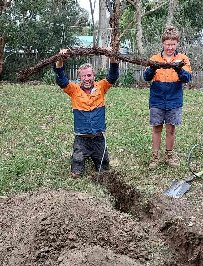 Cre8Flow plumbers holding tree roots removed from a blocked drain in Geelong