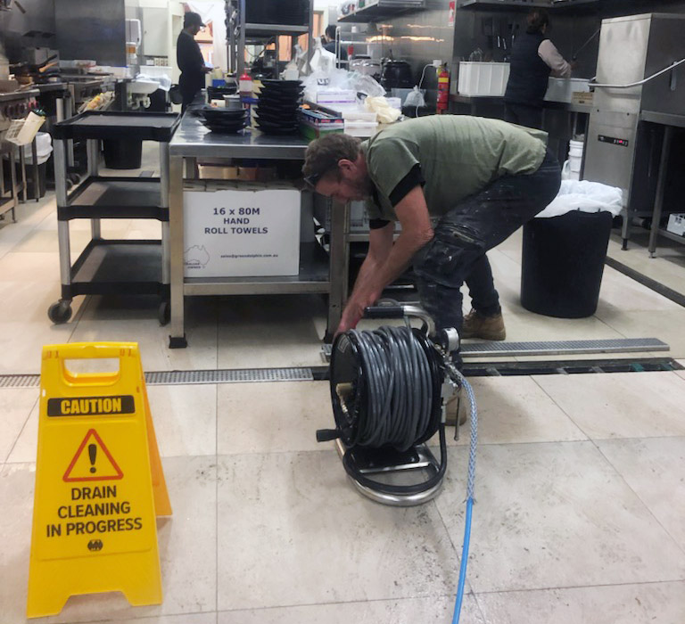 Cre8Flow plumber clearing a blocked drain on a Geelong job site